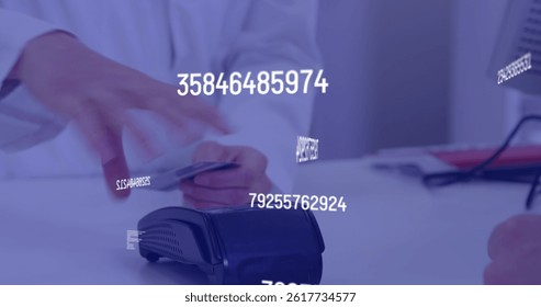 Image of numbers changing over caucasian man paying with card at terminal. global finance, business, digital interface and networks concept digitally generated image.