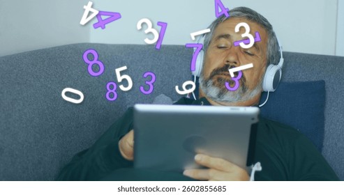 Image of numbers changing over man with headphones on using tablet with . digital interface global connection and communication concept digitally generated image.