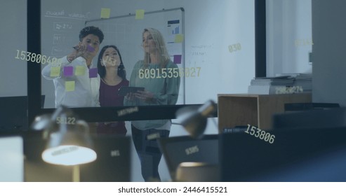 Image of numbers and data processing over diverse business people working in office. Global business, finances, computing and data processing concept digitally generated image.
