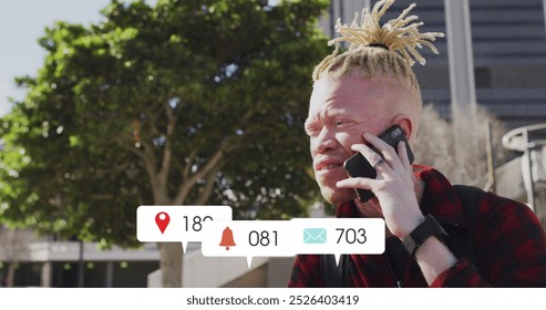 Image of numbers, icons in notification bars, albino african american man talking on cellphone. Digital composite, multiple exposure, business, social media reminder and technology concept. - Powered by Shutterstock