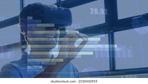 Image of numbers and statistics over caucasian man wearing vr headset. Global business, digital interface and data processing concept digitally generated image.