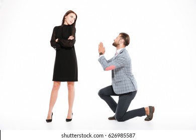 Image Of Offended Young Loving Couple Standing Isolated Over White Background. Looking Aside. Man Ask For Apologize.