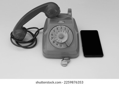 Image of an old rotary phone and a smartphone next to it. The evolution of telephony comparing old and new.
 - Powered by Shutterstock