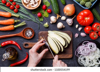 Image on top of fresh vegetables, champignons, cutting board, oil, knife, eggplant, chef's hands - Powered by Shutterstock