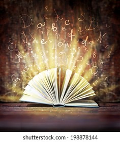 Image of opened magic book with magic lights/ 