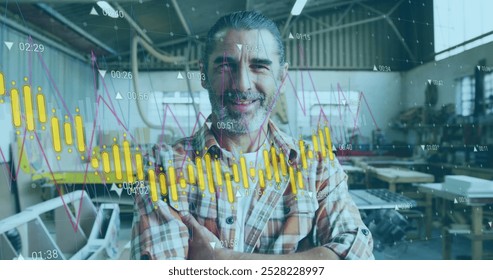 Image of orange graph processing over portrait of happy caucasian male carpenter in workshop. Connection, network, data, small business, craft and carpentry, digitally generated image.