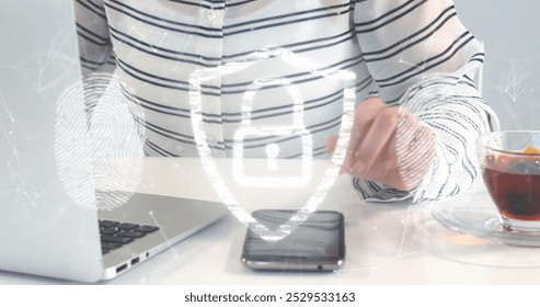 Image of padlock, biometric fingerprints, data processing and networks over man using laptop. Global computing, networks, business, finance and data processing concept digitally generated image.