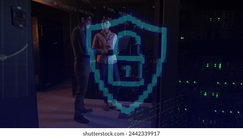 Image of padlock over diverse female and male it engineers by computer servers. data processing, cloud computing concept and technology concept digitally generated image.