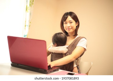 Image Of Parent And Child Using A Personal Computer 