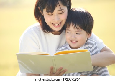 Image Of Parents And Children Reading A Book 