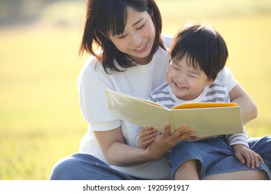 Image Of Parents And Children Reading A Book 