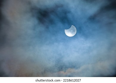 Image of a partial solar eclipse through veil clouds