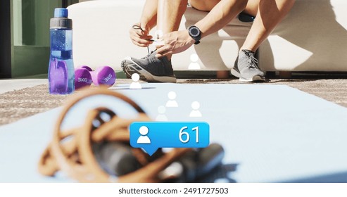 Image of people icon with numbers over african american male athlete tying shoelace. Digital composite, social media, growth, notification, exercise, fitness, hand, leg, preparation. - Powered by Shutterstock