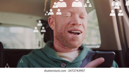 Image of people icons and data processing over african american albino man using smartphone. Global business, computing, data processing and connections concept digitally generated image. - Powered by Shutterstock