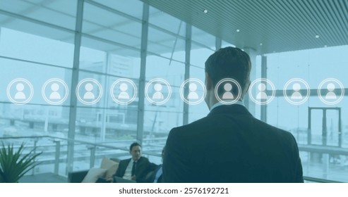 Image of people icons and data processing over diverse business people in office. Global finance, business, connections, computing and data processing concept digitally generated image.