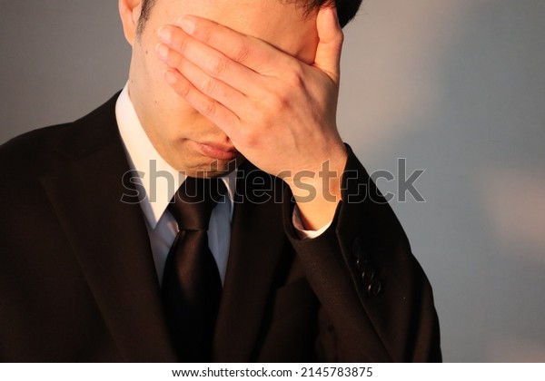 Image of a person\
crying at the funeral