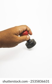 image of a person using his left hand to stamp a document. a sign of having been checked, approved or not and a symbol of a cooperative relationship