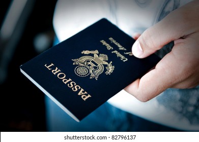 Image of a persons hand holding a passport