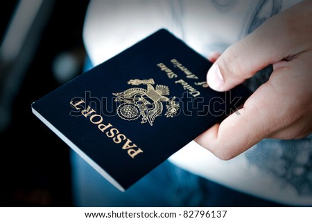 Image of a persons hand holding a passport