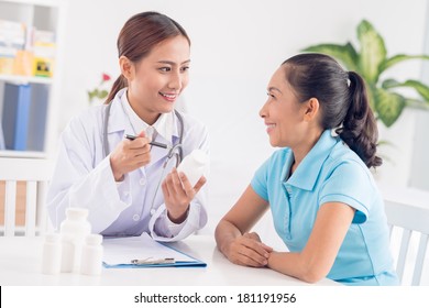 Image Of A Physician Making A Prescription For A Senior Patient On The Foreground 