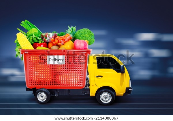 Image of pickup truck\
delivering a box full of groceries while driving with fast motion\
background