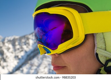 An image with a portrait of a female snowboarder wearing a helmet and glasses with reflection of snow-capped Alps in Grindelwald, Swiss - Shutterstock ID 98835203