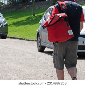 Image of postal worker walking. Spring morning