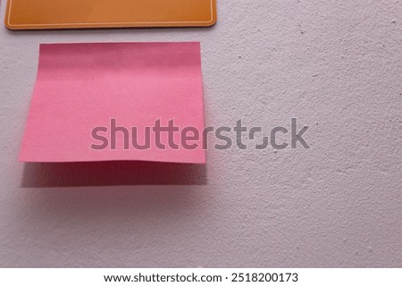 Image of post-its stuck to the wall without writing. They are blank. 
They have different colors, shapes and locations within the photograph.