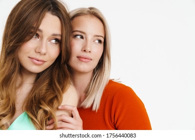 Image Of Pretty Beautiful Two Women Hugging And Looking Aside Isolated Over White Background