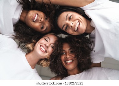 Image of a pretty cheerful young women multiracial friends posing isolated over white wall background looking at camera. - Shutterstock ID 1530272321