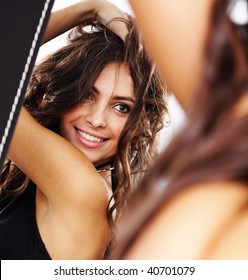 Image of pretty female looking in mirror and enjoying herself