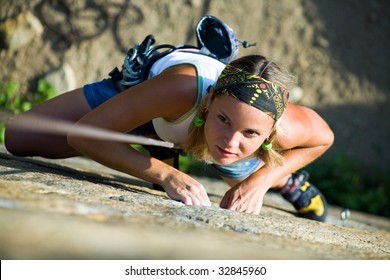 Image of pretty woman climbing on the rock