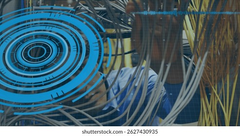 Image of processing circle and data over caucasian man checking servers. Network, data processing and technology concept digitally generated image. - Powered by Shutterstock - Get 15% off with code: PIKWIZARD15