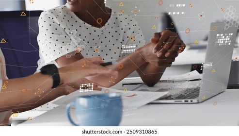 Image of processing data over happy diverse female colleagues using laptop at casual office. Business, connection, teamwork, digital interface and communication, digitally generated image. - Powered by Shutterstock