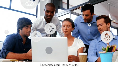 Image of profile icons in circles over diverse coworkers discussing reports on laptop at office. Digital composite, multiple exposure, planning, teamwork, business and technology concept. - Powered by Shutterstock