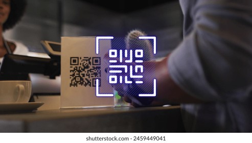 Image of qr code over biracial man paying in cafe with smartwatch. Global business and digital interface concept digitally generated image. - Powered by Shutterstock