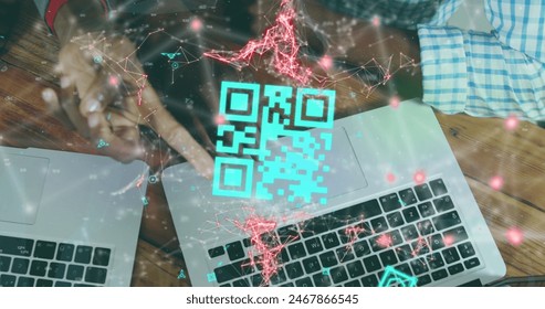 Image of qr code scanner over mid section of diverse people discussing over laptops at office. Digital payments and business technology concept