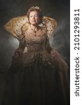 The image of Queen Elizabeth I of the 16th century. Historical reconstruction. The image of the queen in smoke on a gray background. High quality photo