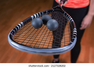 Image of racket and three squash balls. Sports concept. Mixed media