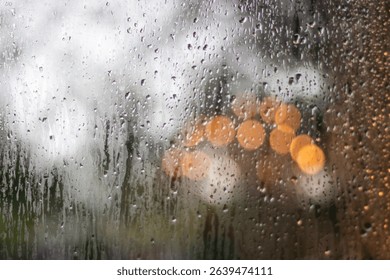 Image of raindrops on window, creating bokeh.