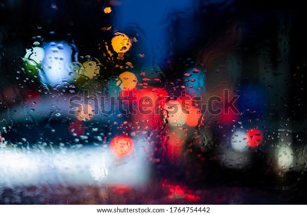 Image of\
raindrops on window at night in the\
city