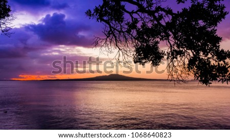 An image of Rangitoto island in the Hauraki Gulf at sunrise from Auckland's east coast in New Zealand.