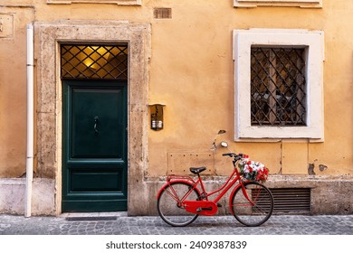 Image of a red bicycle on an old narrow cobblestone street in Rome, Italy. Old street in Rome, Italy. Architecture and landmark of Rome. - Powered by Shutterstock