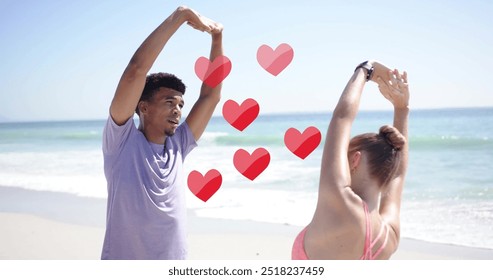 Image of red hearts over diverse couple stretching on beach. Summer, vacation, lifestyle and digital interface concept digitally generated image. - Powered by Shutterstock