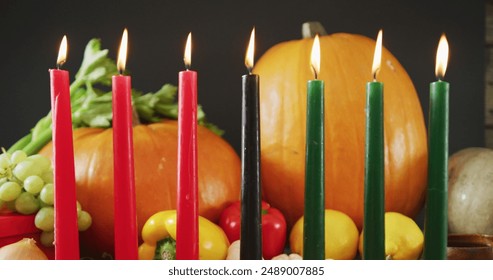 Image of red hearts over kwanzaa candles and pumpkins. Kwanzaa festivity, celebration and tradition concept digitally generated image. - Powered by Shutterstock