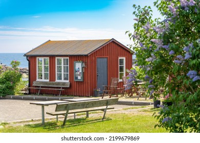 Image Of Red House At Sea Shore In The Baltic Sea. Old Small Fish House In Sweden