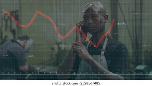Image of red lines and financial data processing over african american man on smartphone. Global computing, digital interface and data processing concept digitally generated image.