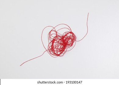 An Image Of Red ,tangled Thread