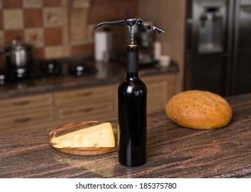 Image of red wine, cheese, bread  in a still life 