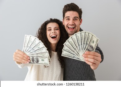 Image Of Rich Man And Woman Holding Fan Of Dollar Money Isolated Over Gray Background